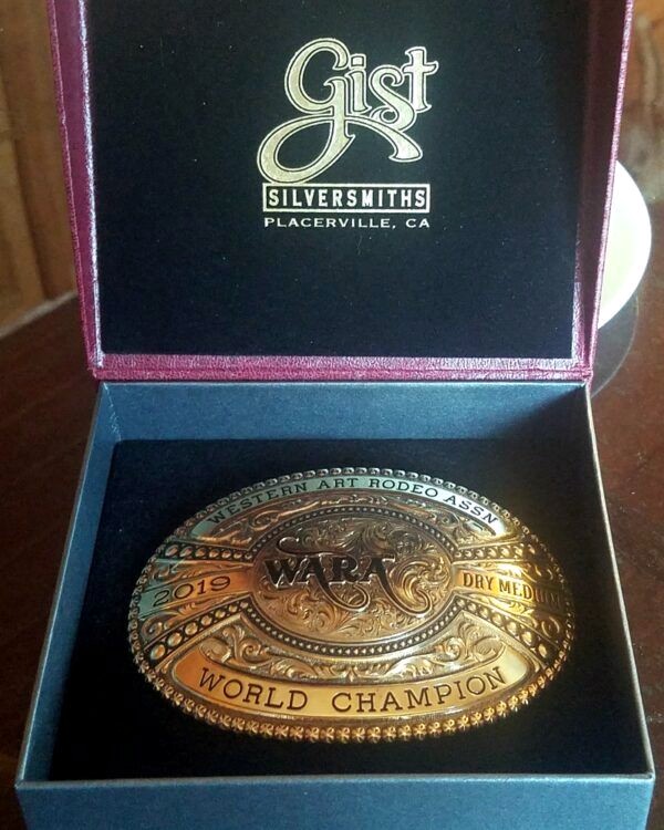 Championship belt buckle awarded to artist Barby Schacher in 2019 for excellence in pastel art